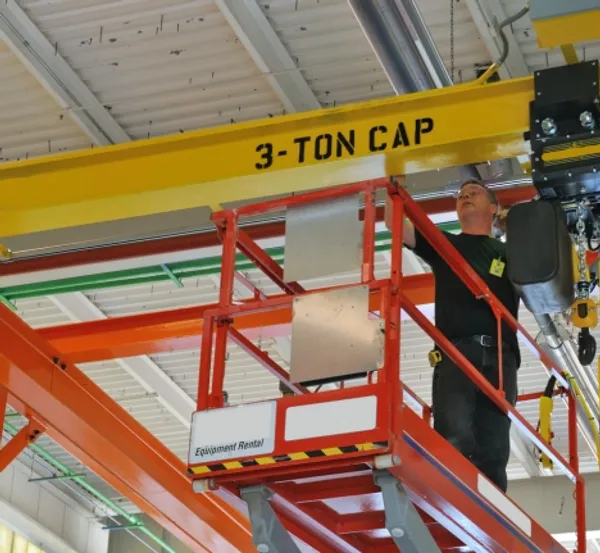 Technician repairing overhead crane